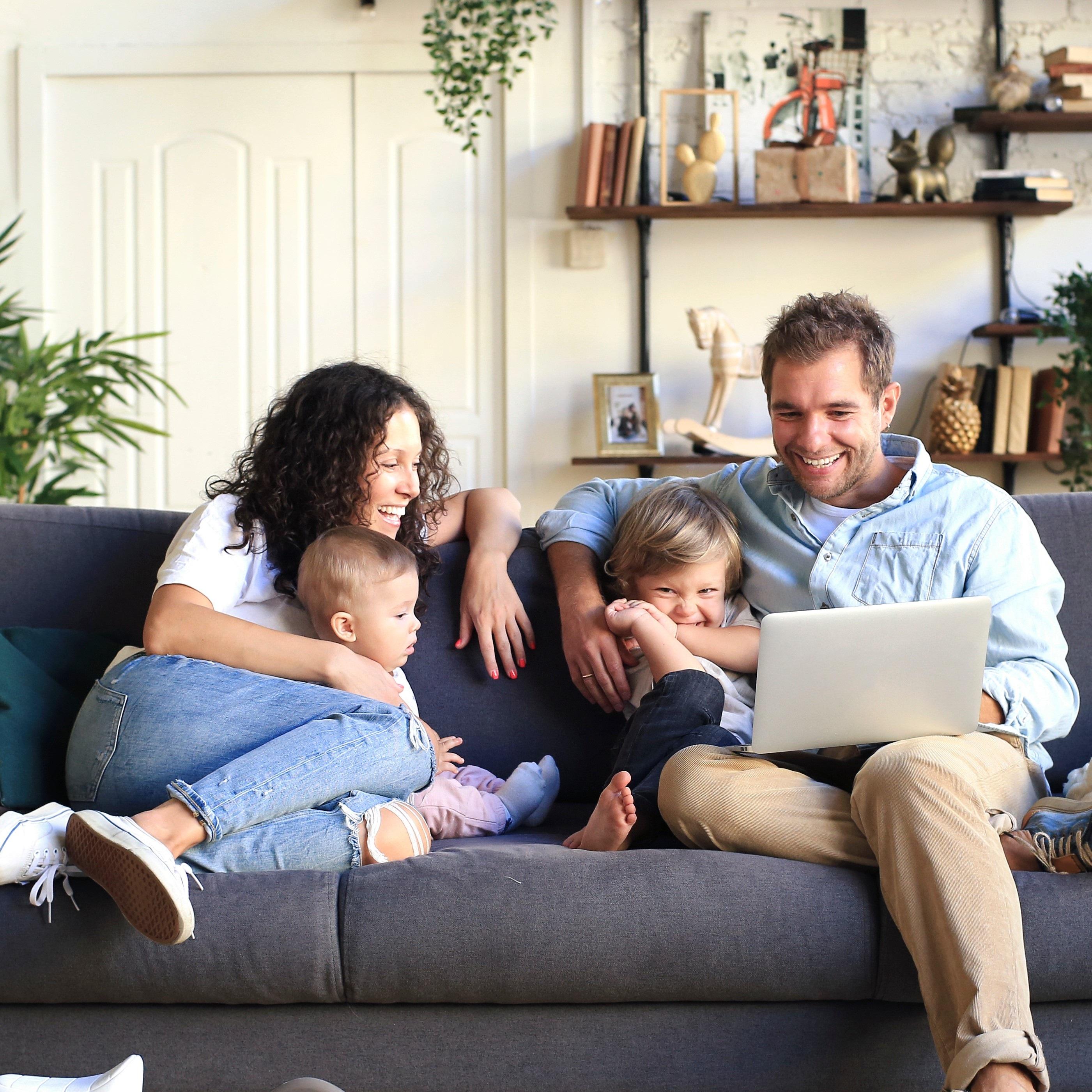 Young beautiful happy family relaxing at home